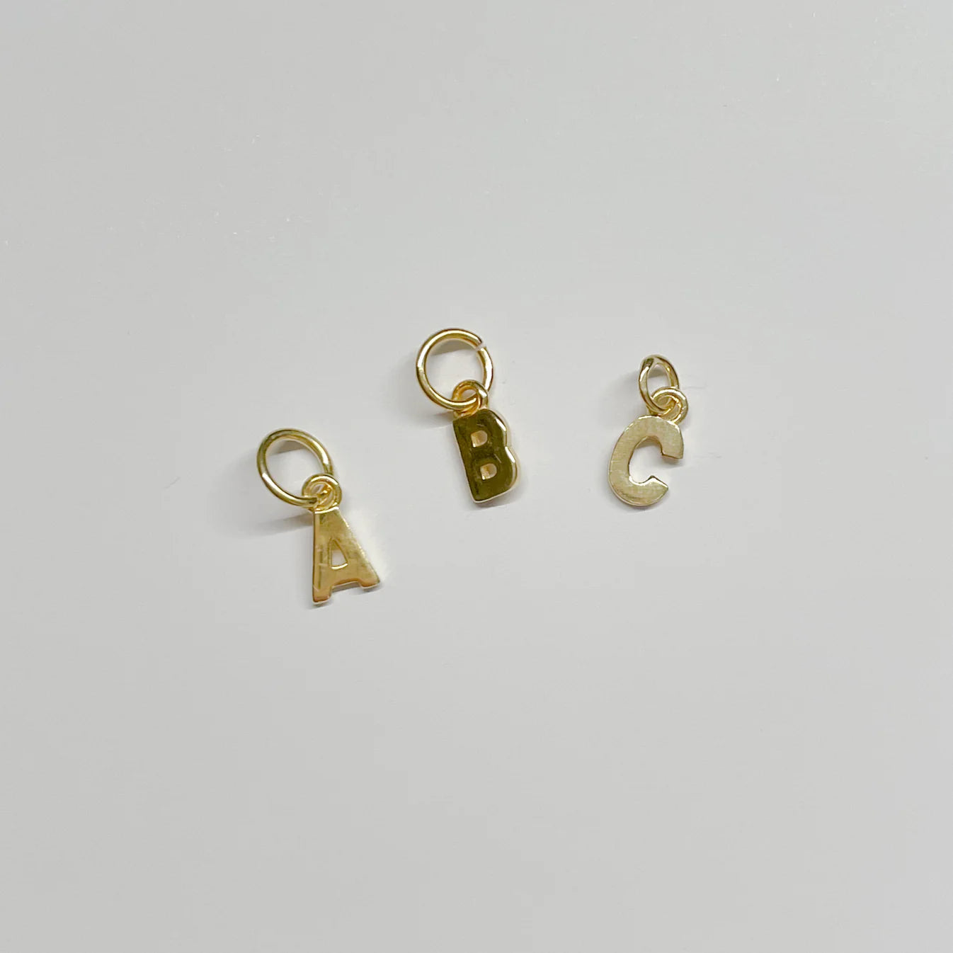 gold tiny letter charm