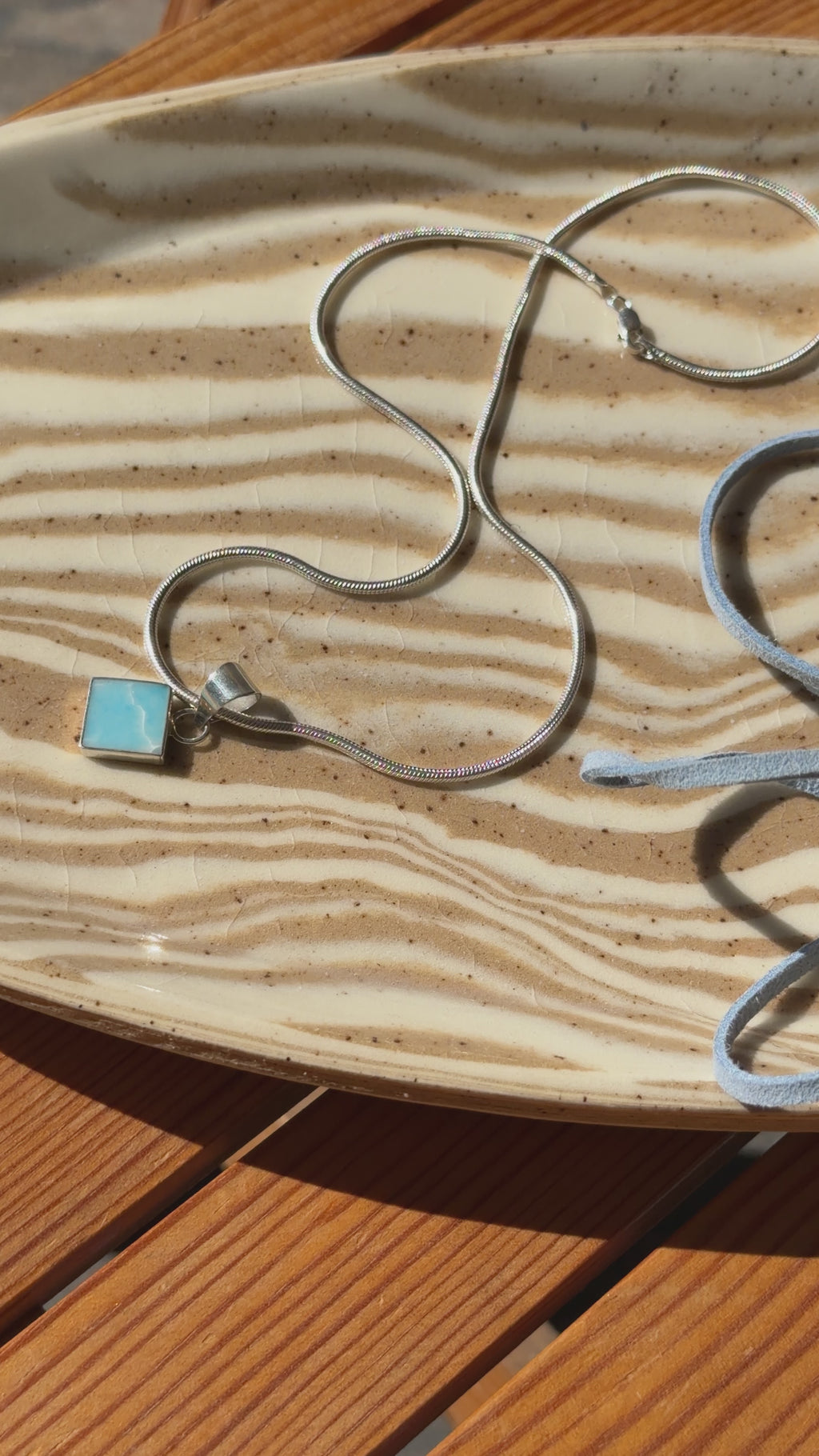 silver pendant on cord