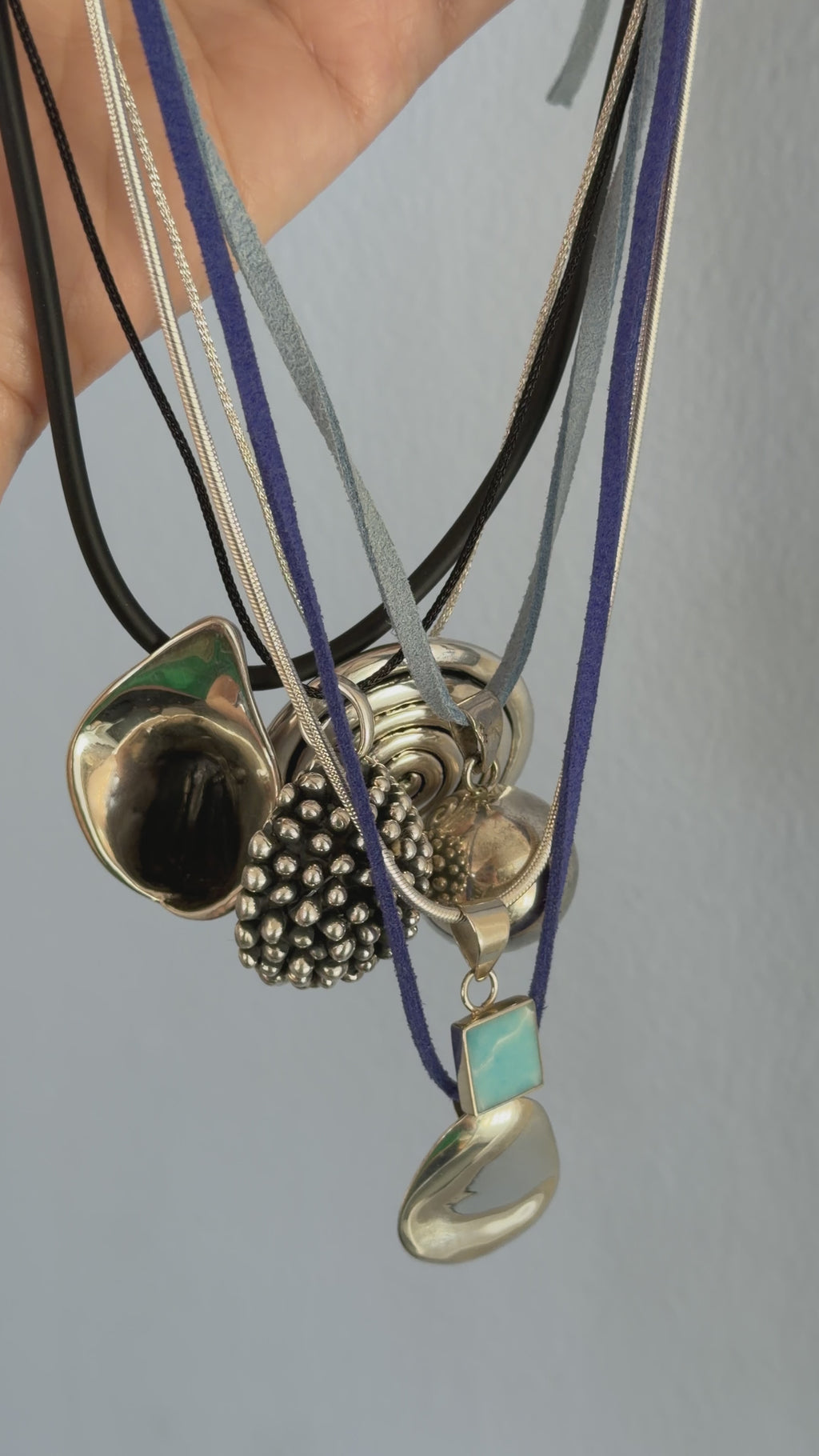 silver pendant on cord